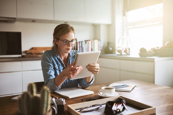 Young woman working from home with a digital tablet