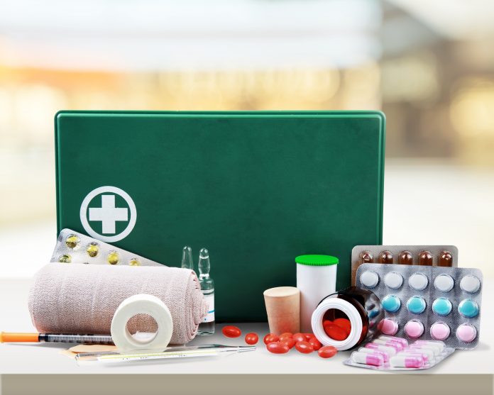First aid kit with medical supplies on